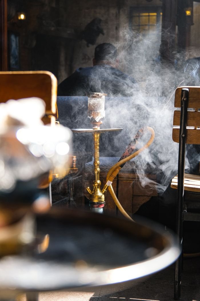 Crafting Captivating Headlines: Your awesome post title goes here Stylish hookah lounge with smoke and cozy seating. Perfect for relaxation.